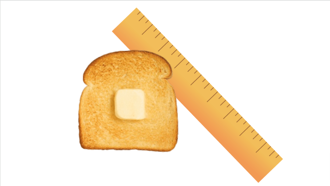 A slice of bread with butter in front of a ruler