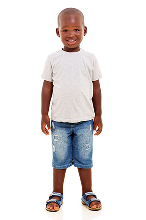A boy wearing a white T-shirt and blue jeans.